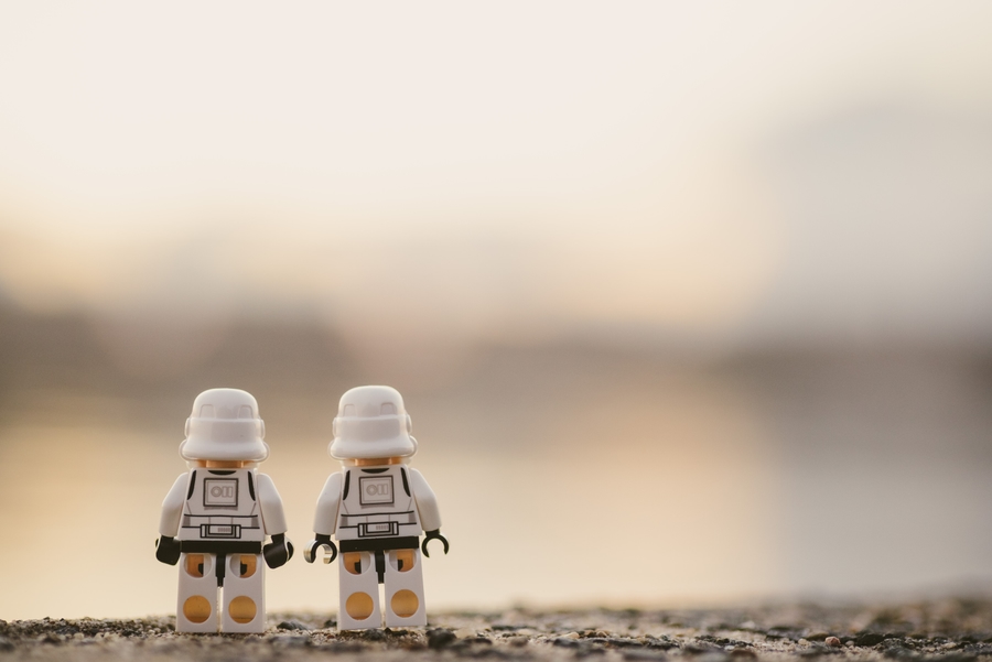 Two lego figures standing next to each other